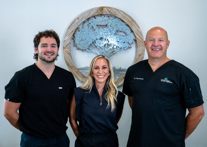 Dr. Austin Brock, Dr. Brynn Van Dyke, and Dr. Tony Brock of Stetson Village Family Dentistry smiling together